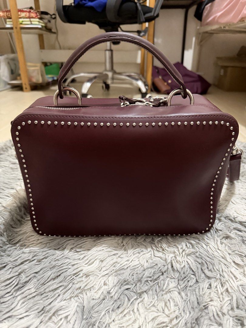 Sequoia Genuine Leather Bag (Category: Shoulder Bags) located in San Mateo. Submitted by swammies (Listing ID 1461248327, Image 1). Description: - Stylish burgundy leather handbag - Edgy studded detailing along the edges - Versatile with top handles and a detachable shoulder strap - Secure zipper closure to keep your belongings safe - Convenient interior zipped pocket for essentials - Minor marks on the exterior, adding character - Ideal for ever