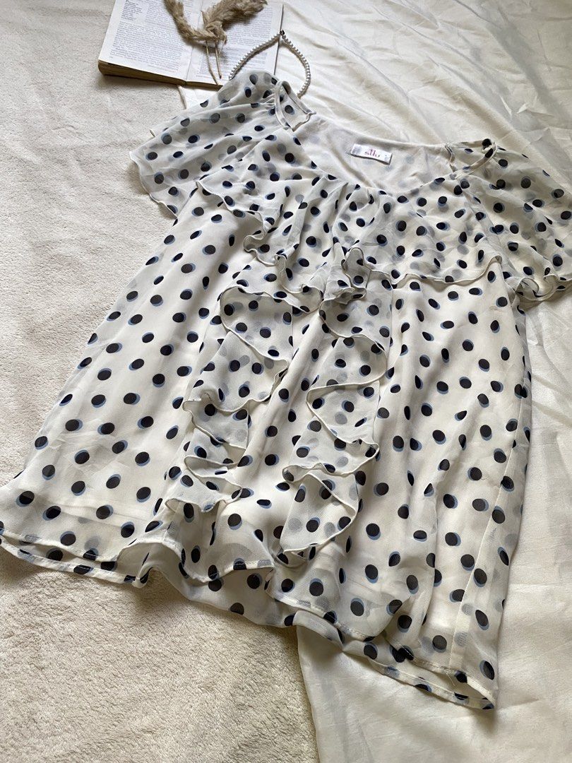 Sheer Polka Dot Ruffle Blouse Small-Med 36 (Category: Blouses) located in Poro. Submitted by joyceyuu (Listing ID 1461303483, Image 2). Description: - Creamy white sheer blouse - Navy polka dot pattern - Ruffled front detail - Flutter sleeves - Lightweight and flowy material - Versatile for layering or standalone wear - Pairs well with jeans or skirts.