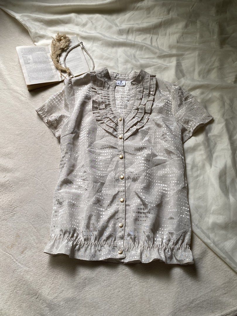 Sheer Ruffled Blouse with Metallic Dot Pattern Small-Med 36 (Category: Blouses) located in Poro. Submitted by joyceyuu (Listing ID 1461302996, Image 1). Description: - Lightweight sheer fabric - Short sleeves - Ruffled neckline and hem - Button-up front - Metallic dot pattern throughout - Versatile for dressing up or down - Easy to layer.