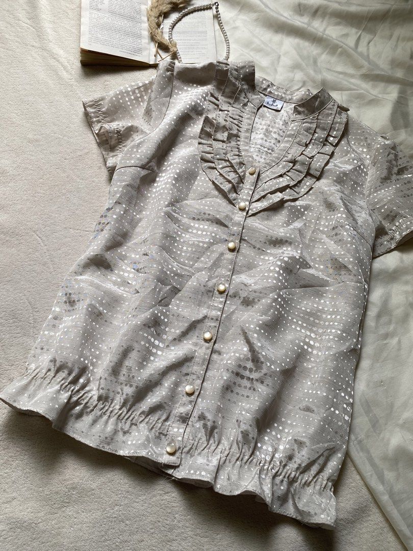 Sheer Ruffled Blouse with Metallic Dot Pattern Small-Med 36 (Category: Blouses) located in Poro. Submitted by joyceyuu (Listing ID 1461302996, Image 2). Description: - Lightweight sheer fabric - Short sleeves - Ruffled neckline and hem - Button-up front - Metallic dot pattern throughout - Versatile for dressing up or down - Easy to layer.