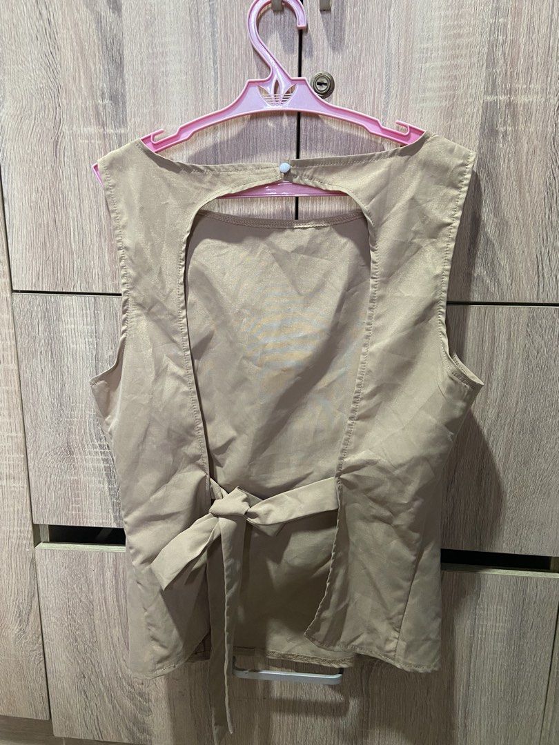 SHEIN Beige Sleeveless Backless Tie Top (Category: Sleeveless) located in Davao. Submitted by asukal.co (Listing ID 1461215596, Image 2). Description: - Beige sleeveless top from SHEIN - Size: Large (L) - Features a stylish cutout back with a tie detail - Material has a satin-like sheen - Reason for selling: does not fit .