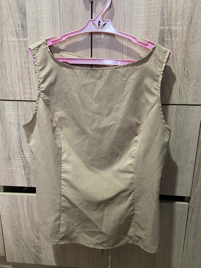 SHEIN Beige Sleeveless Backless Tie Top (Category: Sleeveless) located in Davao. Submitted by asukal.co (Listing ID 1461215596, Image 1). Description: - Beige sleeveless top from SHEIN - Size: Large (L) - Features a stylish cutout back with a tie detail - Material has a satin-like sheen - Reason for selling: does not fit .