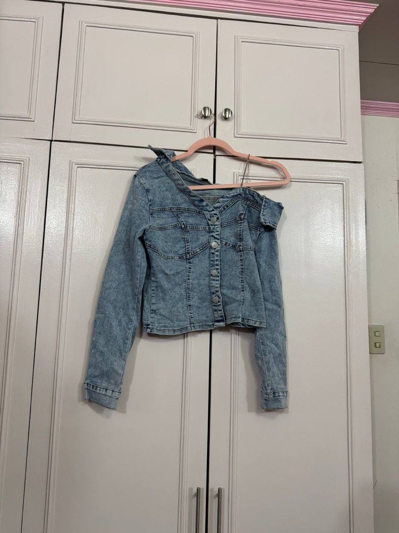 SHEIN Blue Denim Off-Shoulder Jacket Size S (Category: Coats, Jackets and Outerwear) located in Quezon City. Submitted by patzyy (Listing ID 1461279269, Image 1). Description: - SHEIN blue denim jacket - Off-shoulder style - Button-up front closure - Long sleeves with button cuffs - Versatile: pairs well with jeans or skirts - Ideal for casual outings.