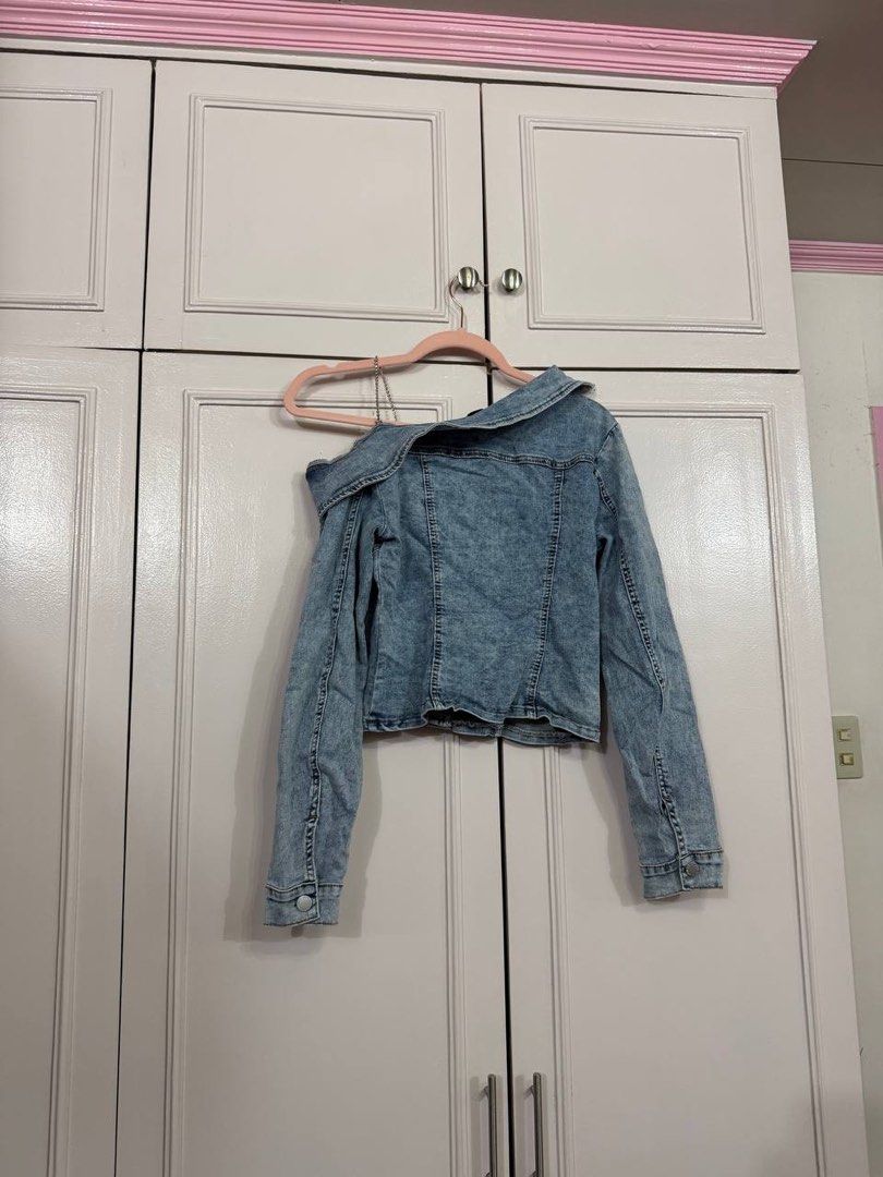 SHEIN Blue Denim Off-Shoulder Jacket Size S (Category: Coats, Jackets and Outerwear) located in Quezon City. Submitted by patzyy (Listing ID 1461279269, Image 2). Description: - SHEIN blue denim jacket - Off-shoulder style - Button-up front closure - Long sleeves with button cuffs - Versatile: pairs well with jeans or skirts - Ideal for casual outings.