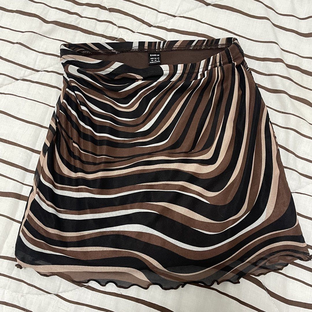 SHEIN Swirl Print Mesh Mini Skirt (Category: Skirts) located in Manila. Submitted by ukhy_shop (Listing ID 1461284585, Image 1). Description: - Swirl print mini skirt - Brown, black, and white wavy pattern - Sheer mesh material with a lettuce hem - Stretchy waistband - Great fit: S 🛒— ₱80 ONLY dm to avail ‼️.
