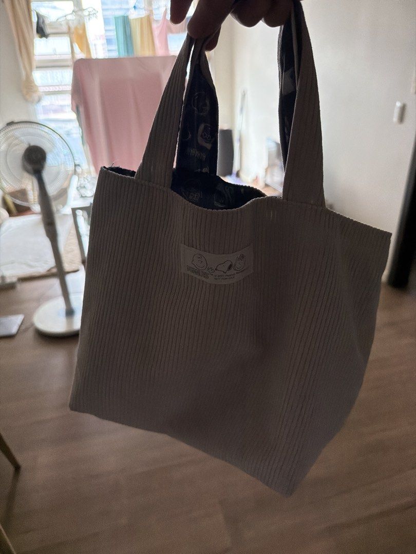 Snoopy Corduroy Tote Bag (Category: Tote Bags) located in Manila. Submitted by treeal (Listing ID 1461158401, Image 1). Description: - Cute light beige corduroy tote bag - Adorable Snoopy tag detail - Pretty floral pattern inside lining - Sturdy handles for durability - Ideal for carrying your daily essentials.