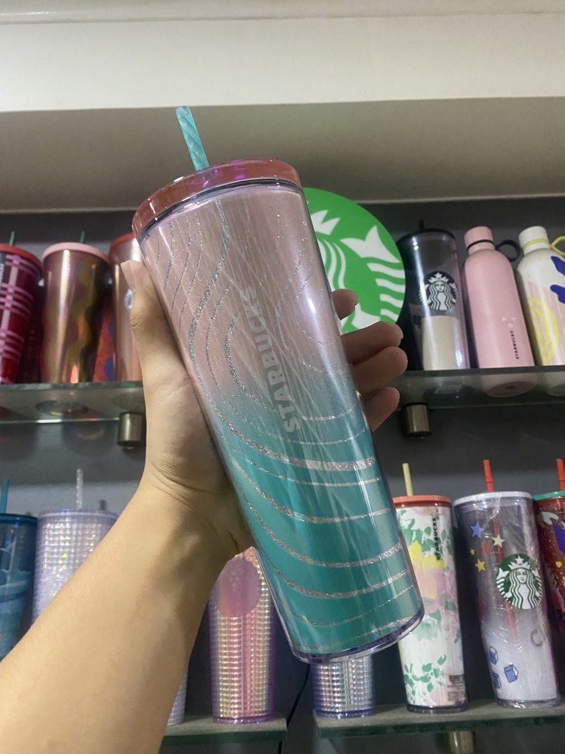 Starbucks Ocean wave (Category: Water Bottles & Tumblers) located in Paranaque City. Submitted by jayisnottyfound (Listing ID 1461201459, Image 1). Description: - Brand: Starbucks - Design: Ocean Wave - Color: Pink to Teal Ombre - Features: Glitter wave pattern, includes straw - Perfect for hot or cold beverages.