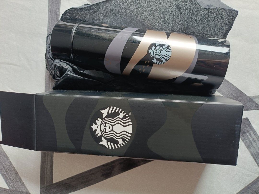 Starbucks Tumbler with Box (Category: Water Bottles & Tumblers) located in Muntinlupa City. Submitted by nkhernande06409 (Listing ID 1461204653, Image 1). Description: - Sleek black Starbucks tumbler - Features elegant gold and grey accents - Iconic Starbucks logo prominently displayed - Includes original patterned box - Excellent for maintaining drink temperature (hot or cold) - A must-have collectible for any Starbucks enthusiast.