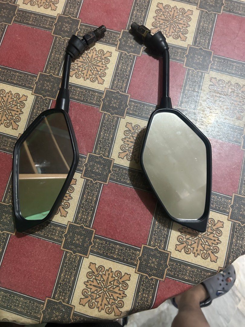 Stock Motorcycle Side Mirrors (Category: Mirrors) located in Manila. Submitted by ravereyes (Listing ID 1461191479, Image 1). Description: - Motorcycle Side Mirrors for Sale - Sleek Black Casing - Clear Reflective Surfaces - Adjustable Stems for Optimal Positioning - Universal Fitment - Compatible with most motorcycles - Upgrade your ride today!.