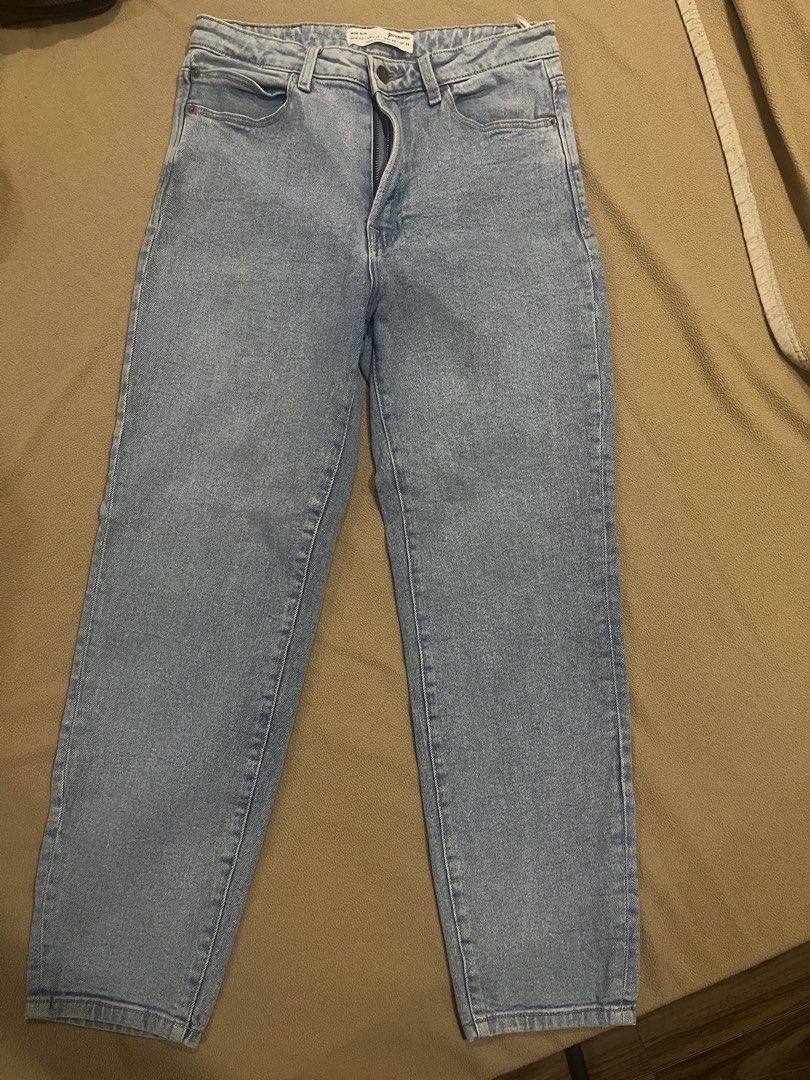 Stradivarius Mom Slim Light Blue Denim Jeans (Category: Jeans) located in Pasig City. Submitted by kakerts (Listing ID 1461277558, Image 1). Description: - Stradivarius Light Blue Mom Jeans - Slim Fit Style - Size: EUR 42 / US 10 / UK 14 - Made in Bangladesh - Classic Five-Pocket Design - Zipper and Button Closure - Perfect wardrobe staple.