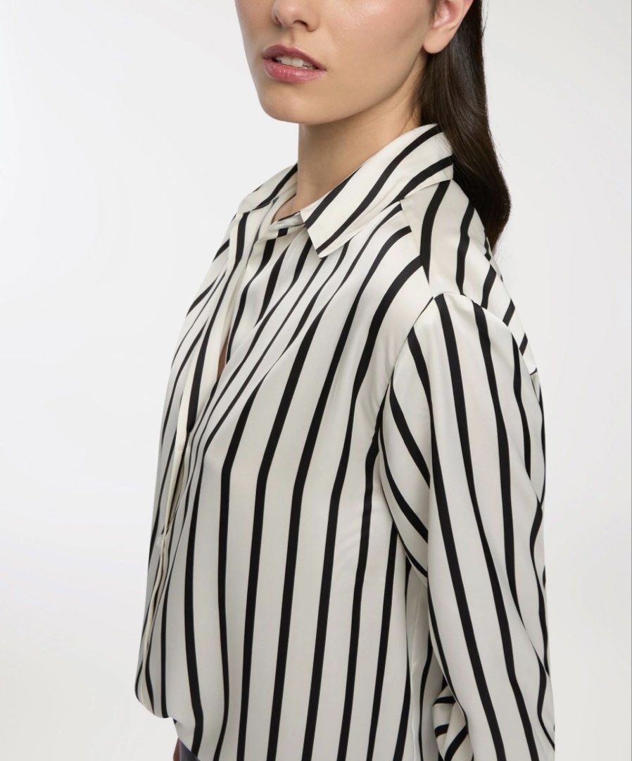 Striped Button-Up Blouse (Category: Blouses) located in Bacolod City. Submitted by bellabianca_closet (Listing ID 1461116203, Image 2). Description: 1st and 2nd pic not mine Never used, just removed tag & laundered - Classic black and white striped pattern - Button-up style - Long sleeves with button cuffs - Pointed collar - Relaxed fit - Versatile for work or casual occasions - Easy to style.