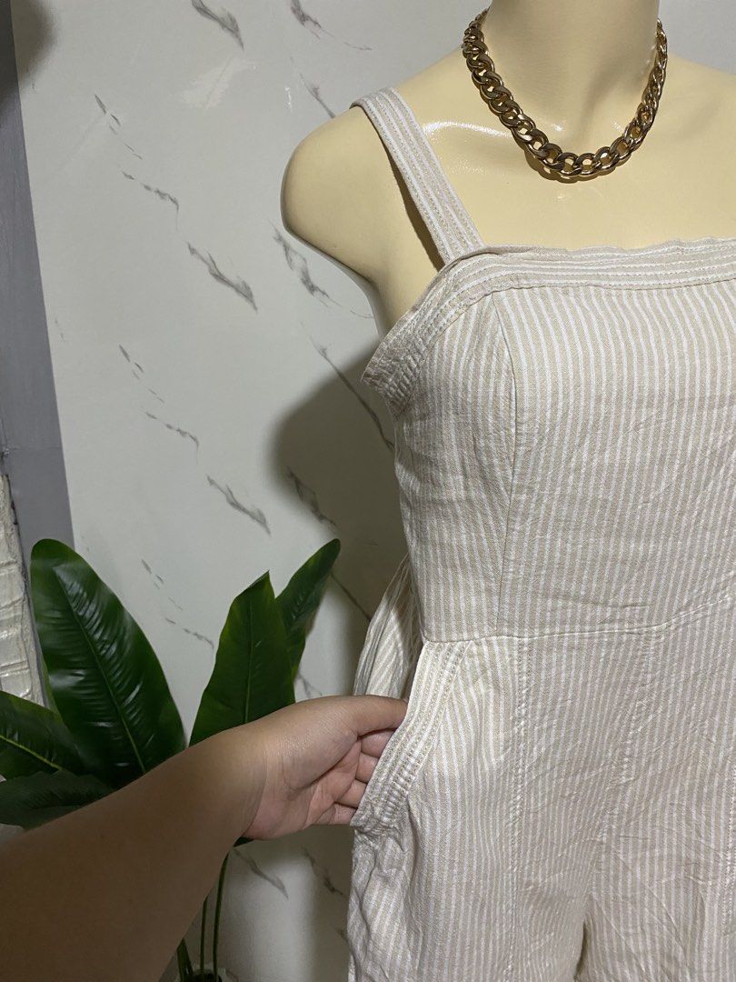 Striped Linen Blend Romper with Smocked Back (Category: Rompers) located in Taguig. Submitted by dinoswear.ph (Listing ID 1461205735, Image 3). Description: - Cute beige and white striped romper - Made from a comfortable linen blend fabric - Features a stylish square neckline - Adjustable straps for a perfect fit - Smocked back for extra comfort - Convenient pockets included - Versatile for casual outings or beach trips - Easy to pair with sandal