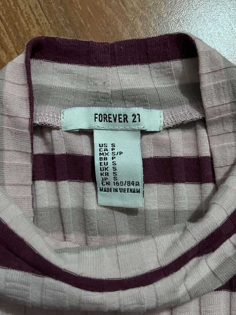 Stripped Turtle Neck Shirt#85 (Category: Longsleeves) located in Caloocan City. Submitted by outfitloop (Listing ID 1461151360, Image 3). Description: - Features horizontal stripes in pink, beige, and burgundy - Stretchy and form-fitting knit - Pairs well with jeans or skirts IMPORTANT: • 1st photo is an AI styling/model preview for reference on how the item may look when worn. • Please refer to the actual photos for the item’s true appearance an