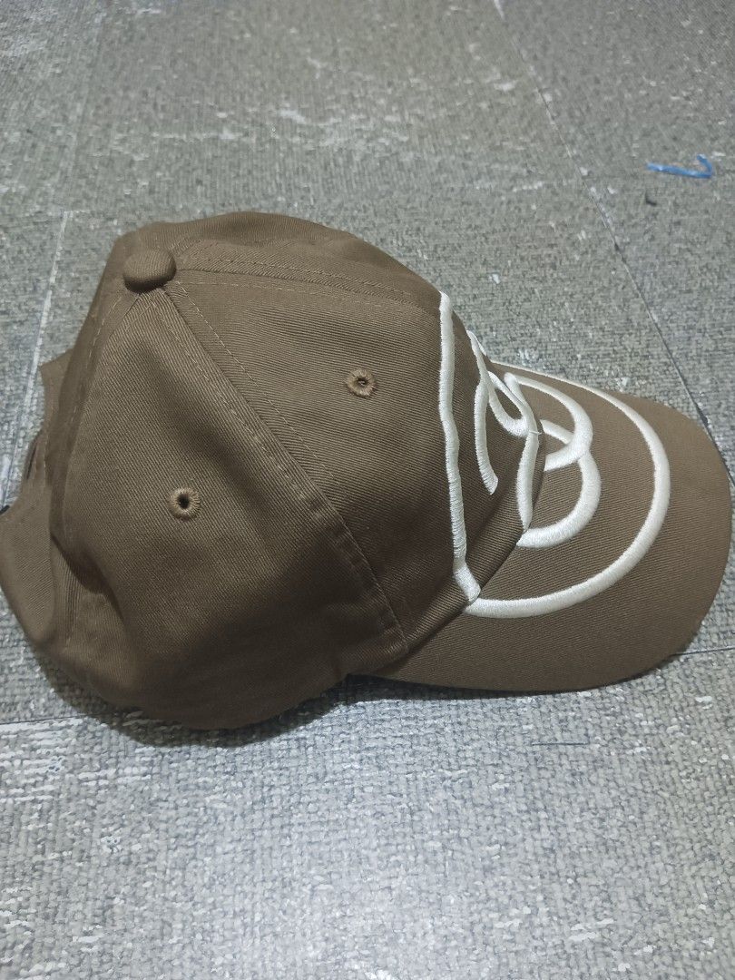 Stussy Brown Cap with White Interlocking Logo (Category: Caps & Hats) located in Tarlac. Submitted by jeffanna1142070 (Listing ID 1461268891, Image 3). Description: STUSSY - Classic brown baseball cap - Features a white interlocking logo embroidered on the front - Six-panel design with ventilation eyelets - Adjustable strap for a custom fit - Ideal for casual outings and everyday style.