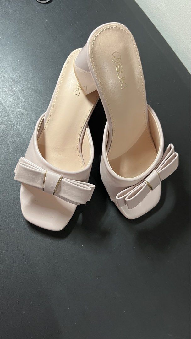 SUKI Pink Bow Block Heels Sandals (Category: Heels) located in Quezon City. Submitted by moms_closet_0306 (Listing ID 1461184332, Image 1). Description: - Brand: SUKI - Color: Pink - Style: Block Heels - Features: Cute bow detail on front strap, square toe, slip-on style - Heel Height: Approx. 2-3 inches - Occasion: Perfect for dressing up or casual wear Used only once (last March 2026 for a wedding).