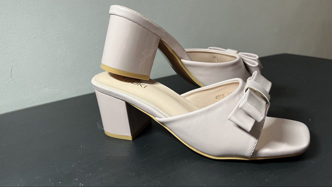 SUKI Pink Bow Block Heels Sandals (Category: Heels) located in Quezon City. Submitted by moms_closet_0306 (Listing ID 1461184332, Image 2). Description: - Brand: SUKI - Color: Pink - Style: Block Heels - Features: Cute bow detail on front strap, square toe, slip-on style - Heel Height: Approx. 2-3 inches - Occasion: Perfect for dressing up or casual wear Used only once (last March 2026 for a wedding).
