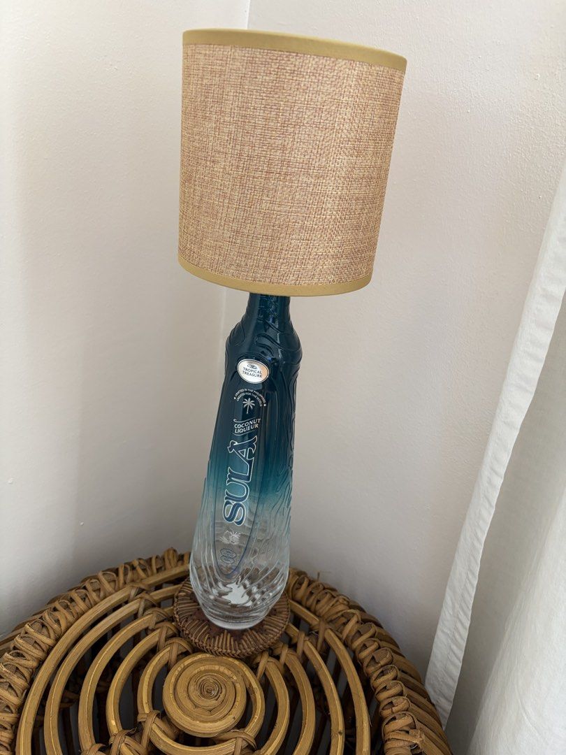 Sula Coconut Liqueur Bottle Lamp (Category: Lighting) located in Quezon City. Submitted by secondhandlifestyle (Listing ID 1461162940, Image 1). Description: Rechargeable lamp. MOP: BPI / GCash Delivery: Same day courier c/o buyer Pick up loc: Eastwood QC.