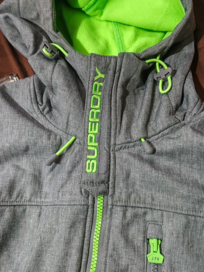 Superdry Original Windtrekker Japan Jacket (Category: Coats, Jackets and Outerwear) located in Caloocan City. Submitted by nebs_seller (Listing ID 1461216289, Image 2). Description: - Grey Superdry Windtrekker jacket - Neon green lining - Features a hood and zip-up front - Ideal for outdoor activities - Made in Japan (check label for details).