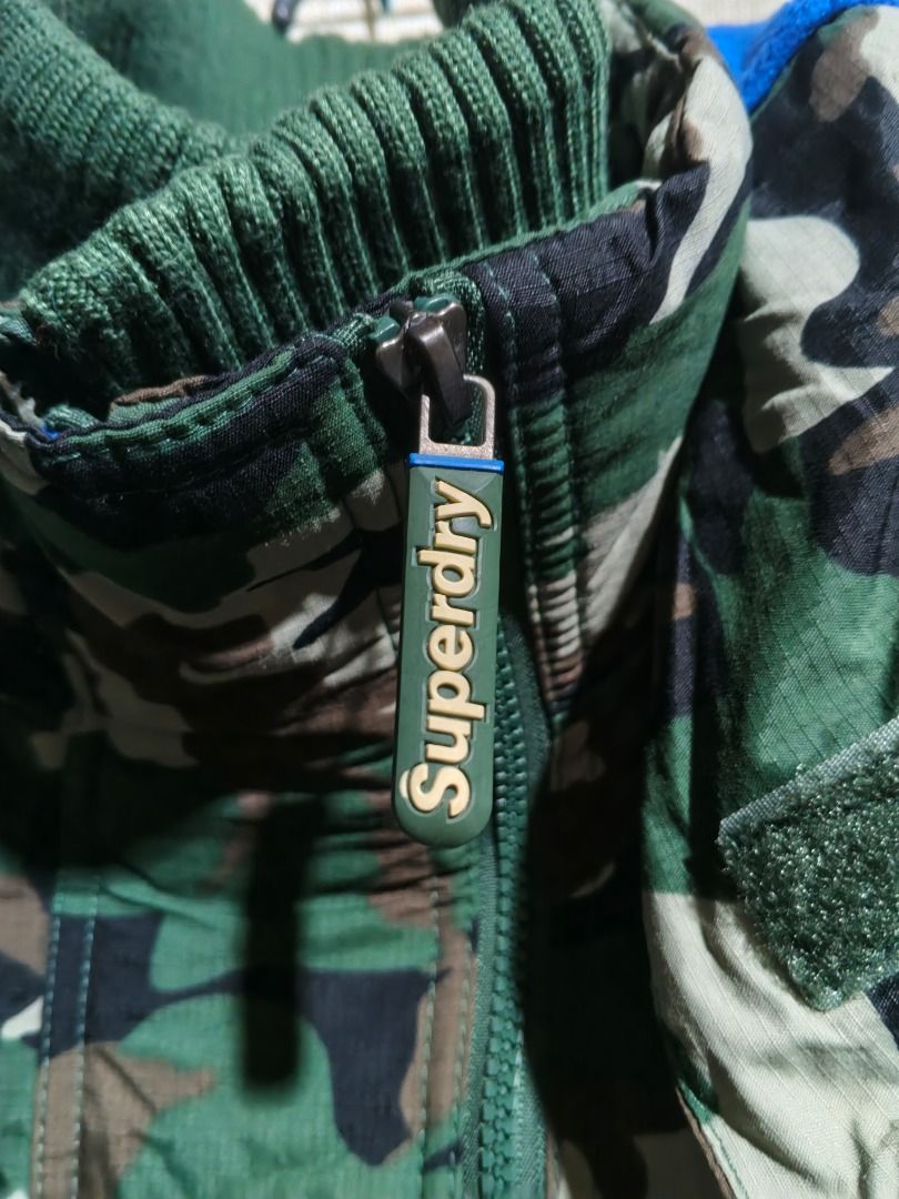 Superdry Professional The Windcheater Camo Jacket XL (Category: Coats, Jackets and Outerwear) located in Caloocan City. Submitted by nebs_seller (Listing ID 1461216510, Image 3). Description: - Superdry Professional Windcheater Jacket - Size: XL - Stylish camouflage print - Features a hood and zip-up front - Ribbed cuffs and collar for a snug fit - Ideal for protection against windy conditions.