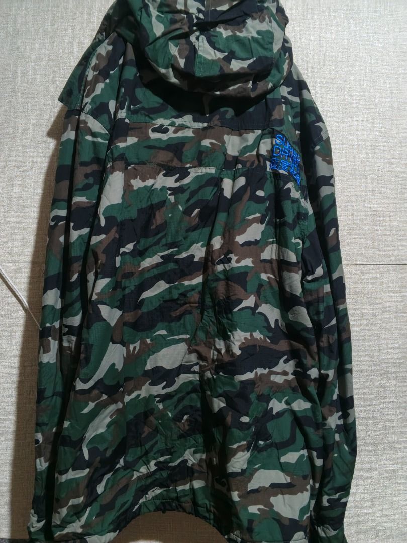 Superdry Professional The Windcheater Camo Jacket XL (Category: Coats, Jackets and Outerwear) located in Caloocan City. Submitted by nebs_seller (Listing ID 1461216510, Image 2). Description: - Superdry Professional Windcheater Jacket - Size: XL - Stylish camouflage print - Features a hood and zip-up front - Ribbed cuffs and collar for a snug fit - Ideal for protection against windy conditions.