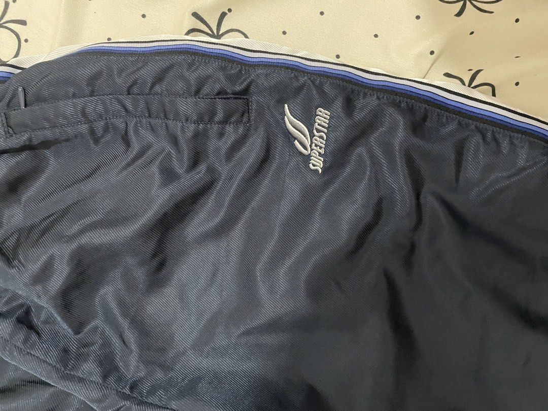 Superstar Navy Blue Track Pants Size S (Category: Other Bottoms) located in Manila. Submitted by puredolphin_e419e1 (Listing ID 1461257957, Image 2). Description: - Navy blue Superstar track pants - White and blue stripes down the sides - Elastic waistband with drawstring - Size S - Ideal for sports or casual wear - Please check photos for detailed condition.