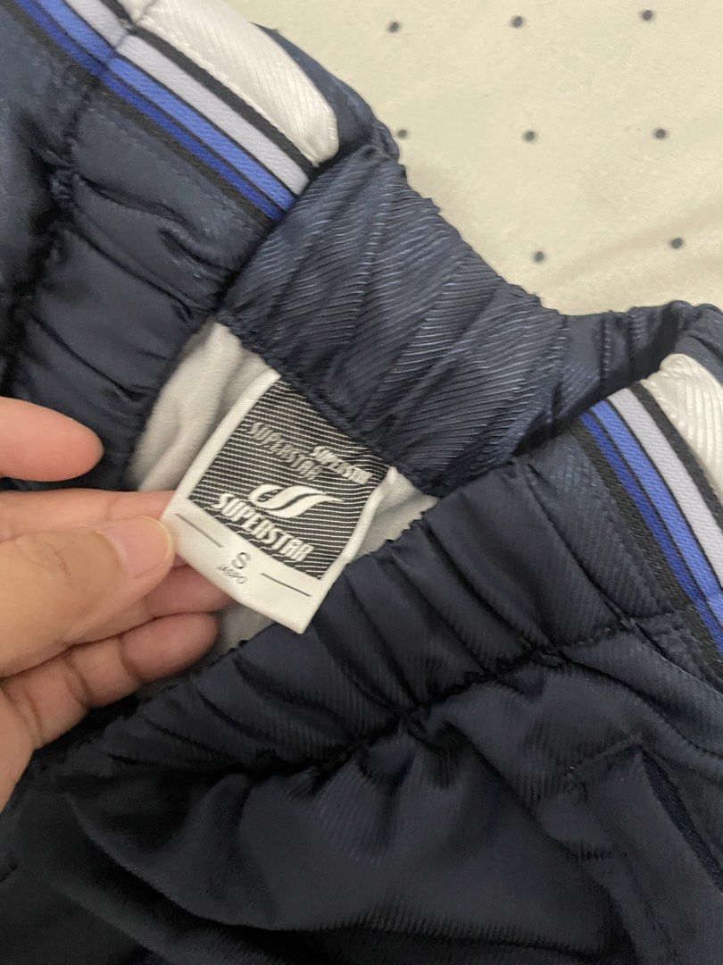 Superstar Navy Blue Track Pants Size S (Category: Other Bottoms) located in Manila. Submitted by puredolphin_e419e1 (Listing ID 1461257957, Image 3). Description: - Navy blue Superstar track pants - White and blue stripes down the sides - Elastic waistband with drawstring - Size S - Ideal for sports or casual wear - Please check photos for detailed condition.