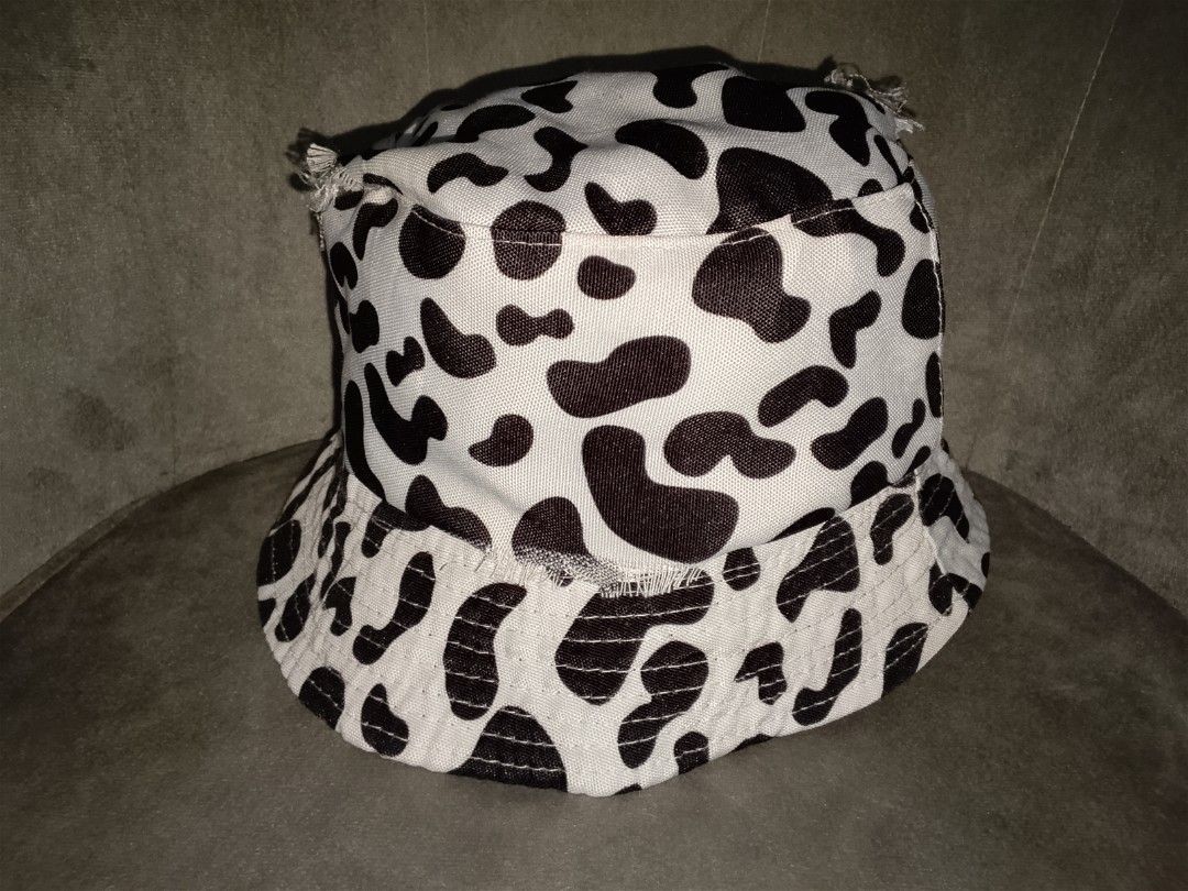 Tattered Cow Print Bucket Hat (Category: Hats & Beanies) located in Binangonan. Submitted by yuristalin888 (Listing ID 1461305619, Image 3). Description: Make a bold statement with this trendy cow-print bucket hat. Featuring a classic black-and-white bovine pattern on durable fabric, this casual streetwear accessory combines effortless style with everyday sun protection. The relaxed silhouette and playful animal print make it an easy go-to piece 