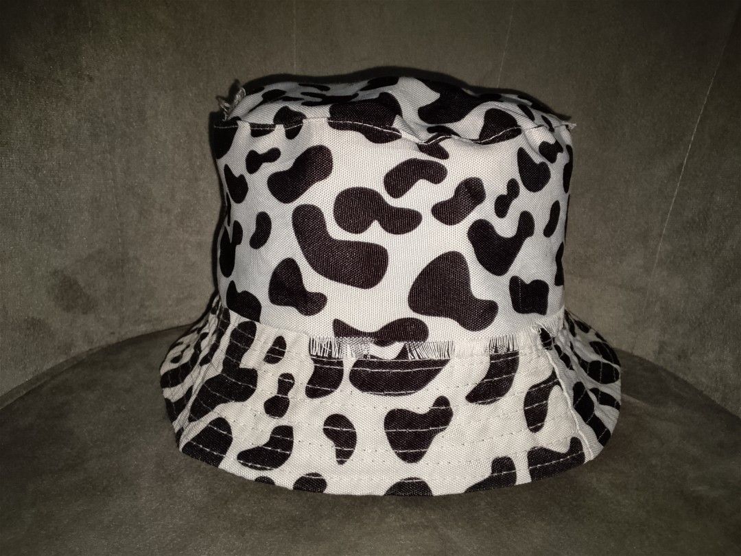 Tattered Cow Print Bucket Hat (Category: Hats & Beanies) located in Binangonan. Submitted by yuristalin888 (Listing ID 1461305619, Image 2). Description: Make a bold statement with this trendy cow-print bucket hat. Featuring a classic black-and-white bovine pattern on durable fabric, this casual streetwear accessory combines effortless style with everyday sun protection. The relaxed silhouette and playful animal print make it an easy go-to piece 