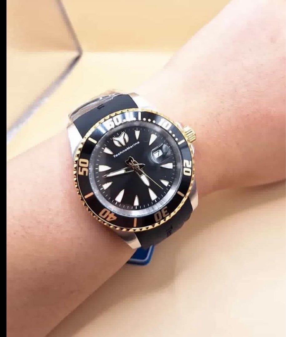TechnoMarine Dive Watch Black Gold Bezel (Category: Men's Watches) located in Manila. Submitted by pre.lovedbyfiaa (Listing ID 1461251909, Image 1). Description: - Brand: TechnoMarine - Dial Color: Black with Gold Accents - Features: Rotating Bezel (ideal for diving) - Condition: Comes in original box - Usage: Suitable for water sports and everyday wear - Reason for Selling: Seldom used.