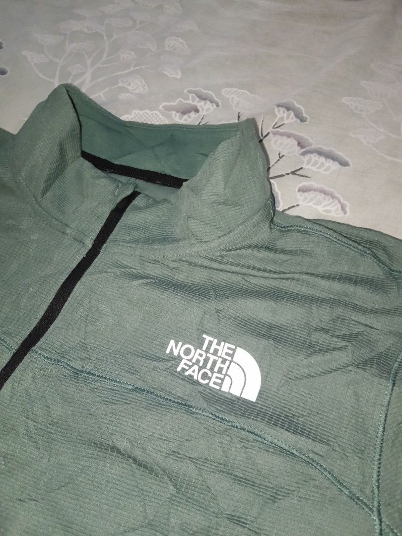 The North Face Green Half Zip Pullover Jacket (Category: Coats, Jackets and Outerwear) located in Lingayen. Submitted by rahzzelula73279 (Listing ID 1461289281, Image 2). Description: - Green The North Face Pullover - Features a half zip and stand-up collar - Size: Tag says US L, fits like Asia XL - Made in Vietnam - Ideal for outdoor adventures or everyday casual wear - Please check photos for condition details.