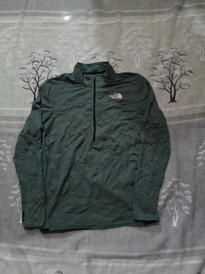 The North Face Green Half Zip Pullover Jacket (Category: Coats, Jackets and Outerwear) located in Lingayen. Submitted by rahzzelula73279 (Listing ID 1461289281, Image 1). Description: - Green The North Face Pullover - Features a half zip and stand-up collar - Size: Tag says US L, fits like Asia XL - Made in Vietnam - Ideal for outdoor adventures or everyday casual wear - Please check photos for condition details.