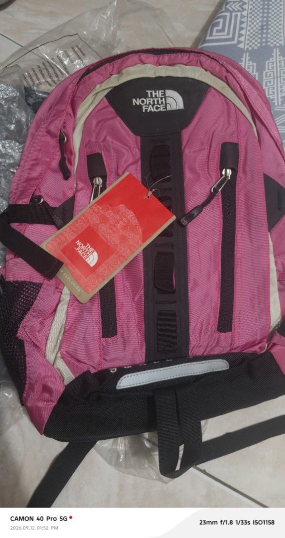 The North Face Small Shot Backpack Pink (Category: Backpacks) located in Mandaluyong City. Submitted by swiftbird_ed6c34 (Listing ID 1461175052, Image 3). Description: - Pink The North Face Small Shot backpack - Multiple zip pockets on the front - Main compartment with internal pockets - Mesh side pockets for water bottles or essentials - Ideal for school, daily use, or day trips - Brand new with original tag still attached.