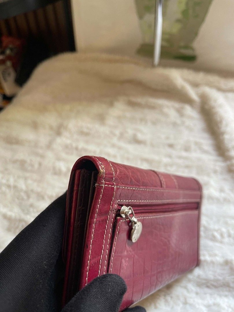 Tino Cosma Embossed Wallet with Snap Closure (Category: Wallets & Card holders) located in Naawan. Submitted by twilly.apparel2 (Listing ID 1461155688, Image 3). Description: - issue crack and sign of use Chic red wallet with a sophisticated croc-embossed finish. - Secure snap closure keeps your belongings safe. - Ample card slots to hold all your essential cards. - Convenient zippered compartment for coins or small items. - Interior lining featu