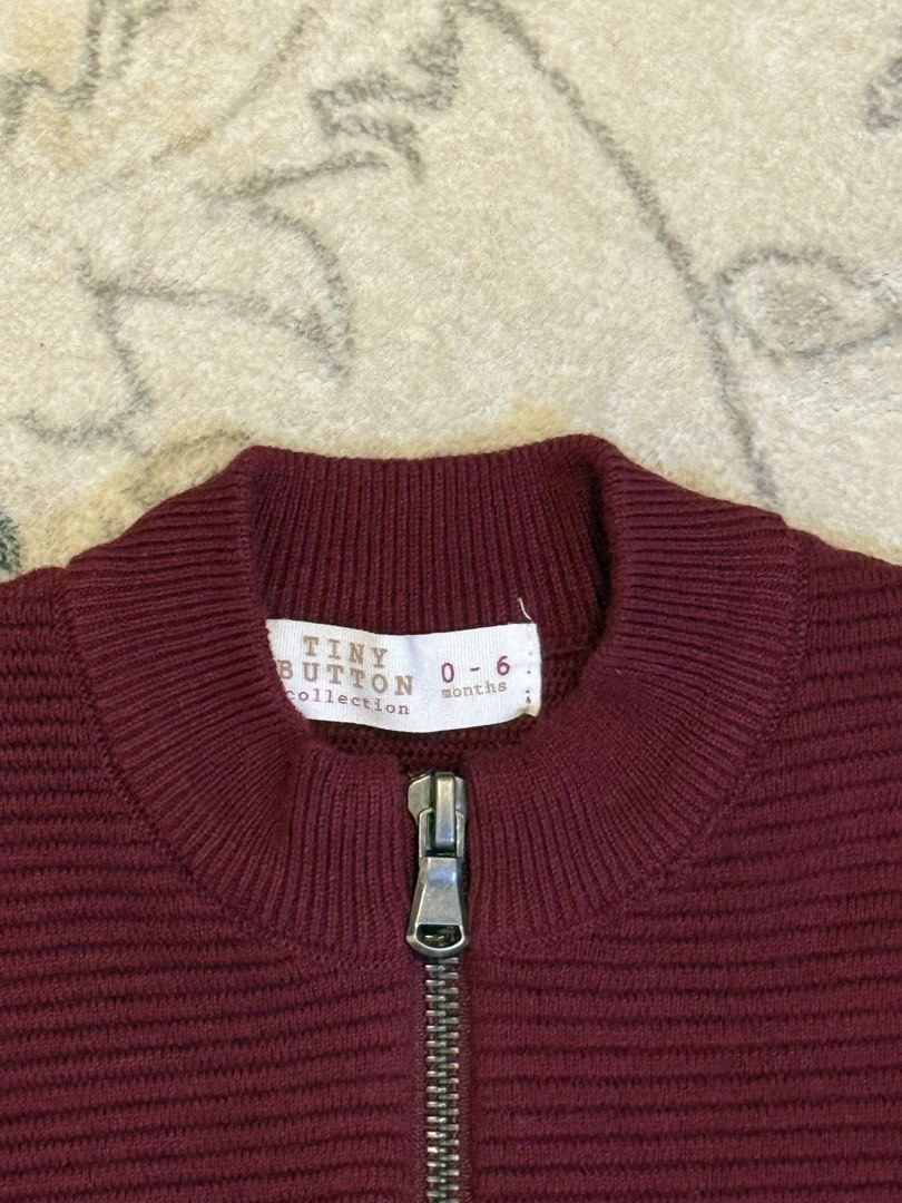 Tiny Button Shirt (Category: Babies & Kids Fashion) located in Seri Kembangan. Submitted by harisostore (Listing ID 1461278130, Image 3). Description: - Brand: Tiny Button - Size: 0-6 Months - Color: Maroon - Style: Bomber jacket - Material: Ribbed knit - Features: Zip-up front, pockets - Condition: Excellent - Gender: Boy.