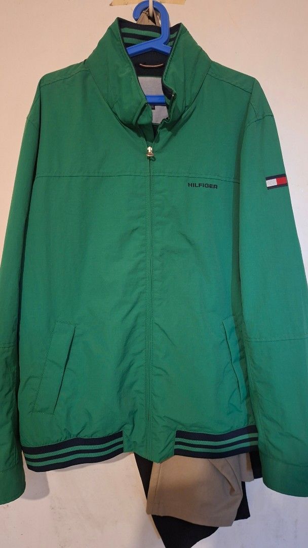 Tommy Hilfiger Green Jacket with Flag Logo (Category: Coats, Jackets and Outerwear) located in Pasay City. Submitted by spliffa24 (Listing ID 1461130098, Image 1). Description: 2XL 26W 30L PACKABLE HOOD Excellent conneed wash only no issues - Classic green Tommy Hilfiger Yachtjacket - Features iconic flag logo on the sleeve - "HILFIGER" text printed on front and back collar - Convenient zip-up front with pockets - Ribbed cuffs and hem accented wi