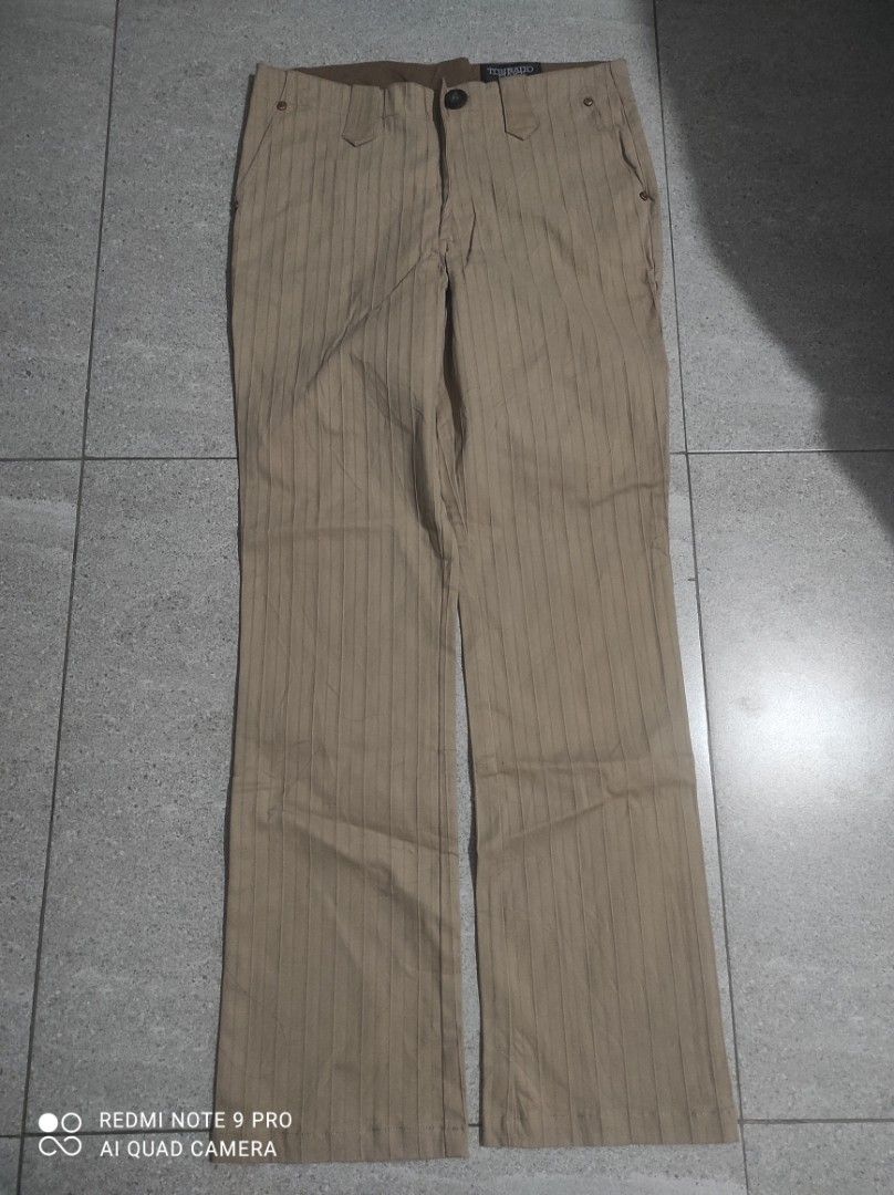 Tornado Mart Striped Pants Size L (Category: Jeans) located in Santa Rosa. Submitted by y2kstylist (Listing ID 1461216938, Image 2). Description: - Tornado Fair Pants - Size: L - Color: Light Brown - Pattern: Subtle Vertical Stripes - Closure: Zip Fly - Style: Casual Wear - Condition: Please check photos for details size 32.
