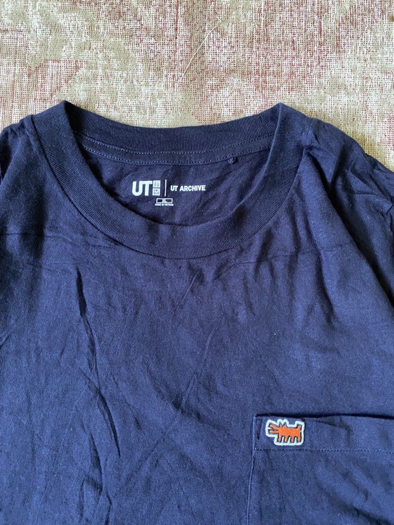 Uniqlo UT Archive Navy Pocket Tee (Category: Tshirts & Polo Shirts ) located in Manila. Submitted by diporosmoh43681 (Listing ID 1461160562, Image 2). Description: - Navy blue Uniqlo UT Archive t-shirt - Features a small embroidered dog graphic on the chest pocket - Short sleeves and a classic crew neck - Ideal for everyday casual wear - Measurements: Pit to pit approx. 23 inches, Length approx. 28 inches.