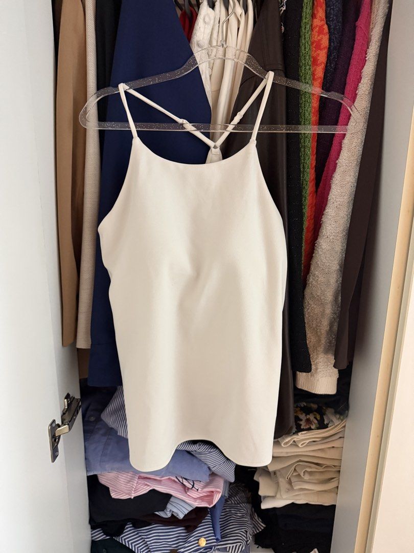 Uniqlo White Tank Top Size M (Category: Sleeveless) located in Manila. Submitted by jimmy_juniorrr (Listing ID 1461149820, Image 1). Description: - Uniqlo White Tank Top - Size: M (fits bust 80-86cm) - Material: Body - 96% Polyester, 4% Spandex; Mesh - 79% Nylon, 21% Spandex; Lining - 100% Polyester - Origin: Made in Vietnam - Care: Wash darks separately. Do not soak, bleach, or dry clean. Iron damp with press cloth..