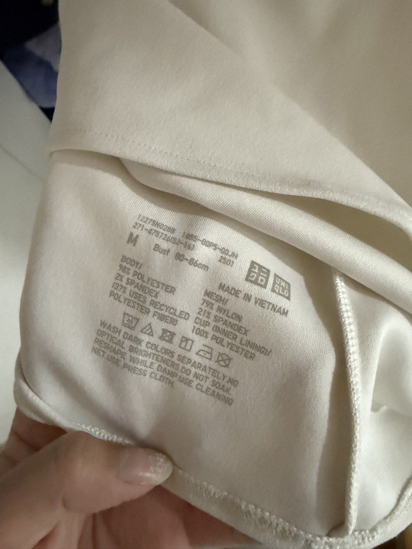 Uniqlo White Tank Top Size M (Category: Sleeveless) located in Manila. Submitted by jimmy_juniorrr (Listing ID 1461149820, Image 2). Description: - Uniqlo White Tank Top - Size: M (fits bust 80-86cm) - Material: Body - 96% Polyester, 4% Spandex; Mesh - 79% Nylon, 21% Spandex; Lining - 100% Polyester - Origin: Made in Vietnam - Care: Wash darks separately. Do not soak, bleach, or dry clean. Iron damp with press cloth..