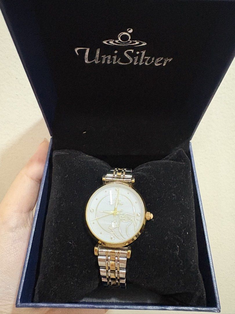 UniSilver Time Watch with Rose accent (Category: Women's Watches) located in Manila. Submitted by alyannaros79007 (Listing ID 1461259707, Image 2). Description: - UniSilver Time watch - White dial with elegant gold accents - Two-tone silver and gold bracelet - Needs Battery - Japan Movement - Comes with original box and guarantee card - Extra links included for a perfect fit - Features a unique design on the watch face - Versatile for everyday we