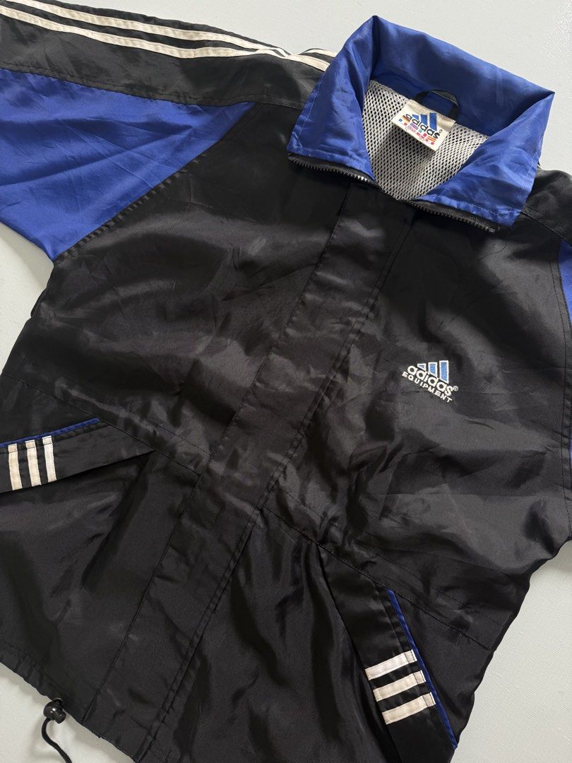VINTAGE ADIDAS PACKABLE WIND BREAKER (Category: Coats, Jackets and Outerwear) located in Cavite. Submitted by chooseyouroutfit (Listing ID 1461246390, Image 3). Description: VINTAGE ADIDAS WIND BREAKER - Embroid - Have back logo - drawstring - packable hood Length - 27 Width - 22 Excellent condition Issue: Loose ribbings Check detailed pictures in comment Price direct message me 📩.
