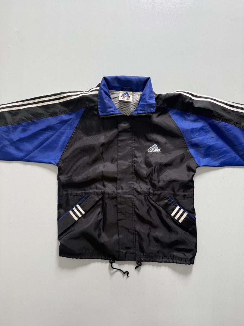 VINTAGE ADIDAS PACKABLE WIND BREAKER (Category: Coats, Jackets and Outerwear) located in Cavite. Submitted by chooseyouroutfit (Listing ID 1461246390, Image 2). Description: VINTAGE ADIDAS WIND BREAKER - Embroid - Have back logo - drawstring - packable hood Length - 27 Width - 22 Excellent condition Issue: Loose ribbings Check detailed pictures in comment Price direct message me 📩.