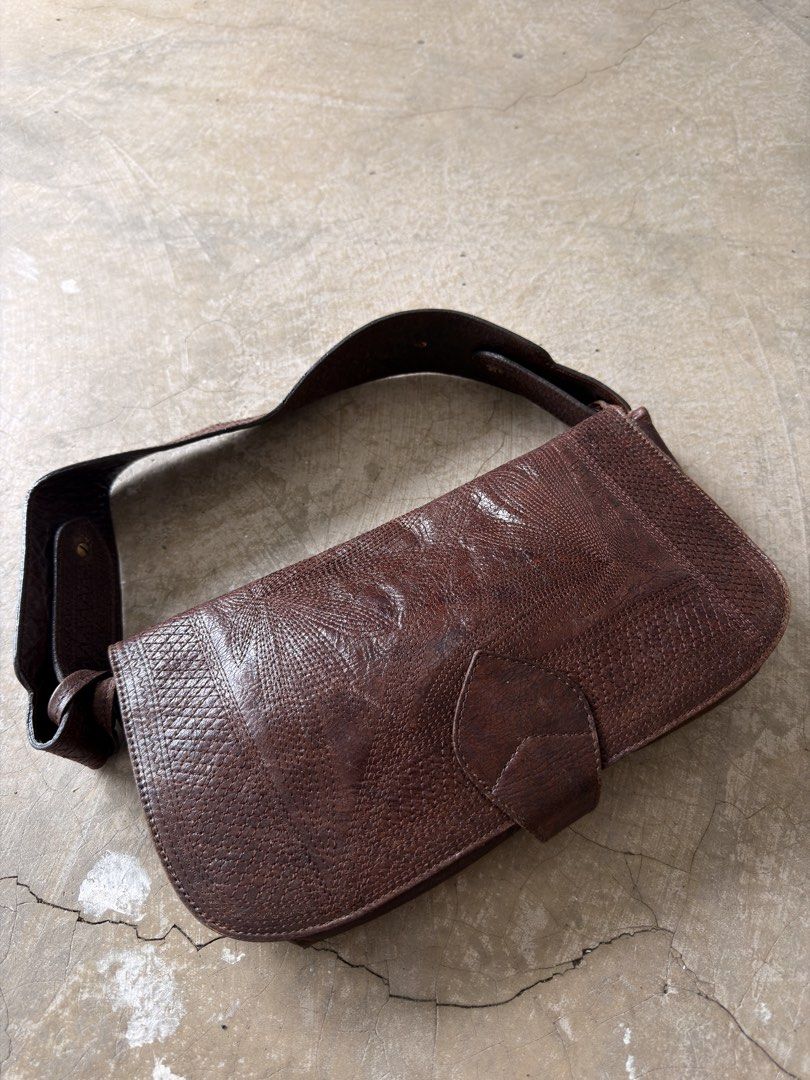 vintage Kenzo brown embossed leather shoulder bag (Category: Shoulder Bags) located in Alfonso. Submitted by jbcamet (Listing ID 1461282949, Image 2). Description: - Genuine brown leather shoulder bag - Unique all-over embossed pattern - Adjustable strap with brass hardware - Secure button tab flap closure - Spacious main compartment - Perfect for daily use.