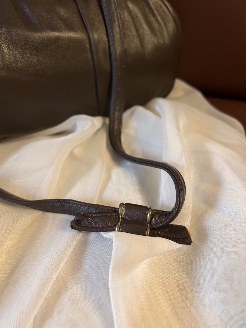 VINTAGE LIKE SHOULDER BAG (Category: Cross-body Bags) located in Baguio. Submitted by chmlnstudio (Listing ID 1461297647, Image 2). Description: Product Details ✦ Style/Silhouette: Vintage Framed Shoulder Bag / Pouch Bag ✦ Color: Deep Espresso Brown / Dark Chocolate ✦ Material & Texture: Soft, supple leather body with gathered top pleating Hardware & Closure: ⟡ Gold-tone metal top frame with classic lift/press lock closure ⟡ Tubular leather shoul