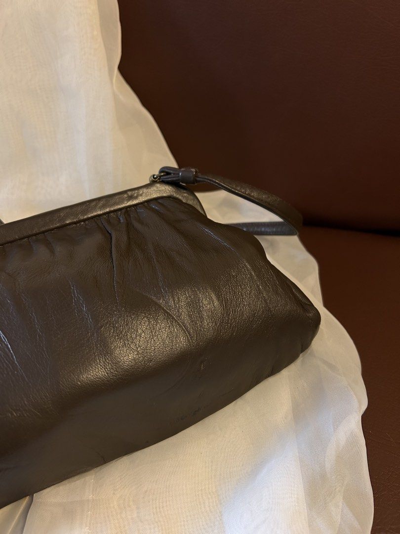 VINTAGE LIKE SHOULDER BAG (Category: Cross-body Bags) located in Baguio. Submitted by chmlnstudio (Listing ID 1461297647, Image 3). Description: Product Details ✦ Style/Silhouette: Vintage Framed Shoulder Bag / Pouch Bag ✦ Color: Deep Espresso Brown / Dark Chocolate ✦ Material & Texture: Soft, supple leather body with gathered top pleating Hardware & Closure: ⟡ Gold-tone metal top frame with classic lift/press lock closure ⟡ Tubular leather shoul