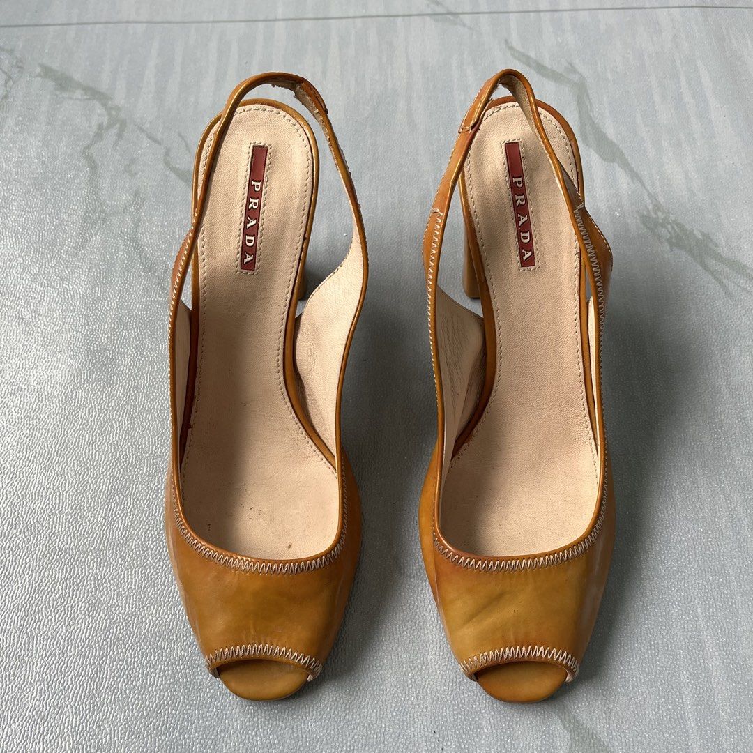 Vintage Prada Leather Peep-Toe Slingback Heels (Authentic) (Category: Heels) located in Cavite. Submitted by newclassicwear (Listing ID 1461207188, Image 3). Description: Size 38 Used Excellent Condition Used But Not Abused (minor scuffs on heels and soles from normal wear plenty of life left) - Brand: Prada - Material: Brown Patent Leather - Style: Slingback Heels - Toe Style: Peep-toe - Heel Type: Chunky Block Heel - Condition: Minor scuffs on 