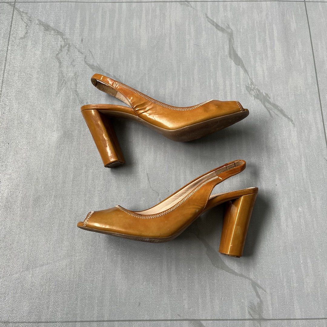 Vintage Prada Leather Peep-Toe Slingback Heels (Authentic) (Category: Heels) located in Cavite. Submitted by newclassicwear (Listing ID 1461207188, Image 2). Description: Size 38 Used Excellent Condition Used But Not Abused (minor scuffs on heels and soles from normal wear plenty of life left) - Brand: Prada - Material: Brown Patent Leather - Style: Slingback Heels - Toe Style: Peep-toe - Heel Type: Chunky Block Heel - Condition: Minor scuffs on 