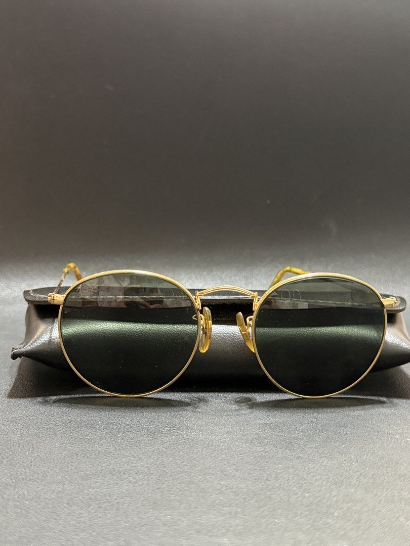 Vintage Rayban Unisex (Category: Sunglasses & Eyewear) located in Manila. Submitted by prelovedbylkt (Listing ID 1461130097, Image 2). Description: - Original Rayban (Vintage) - Unisex - Classic gold frame sunglasses - Round black lenses - Comes with a black protective case - Ideal for sunny days - Simple and stylish design - Great for everyday wear NEGOTIABLE RFS: Decluttering.