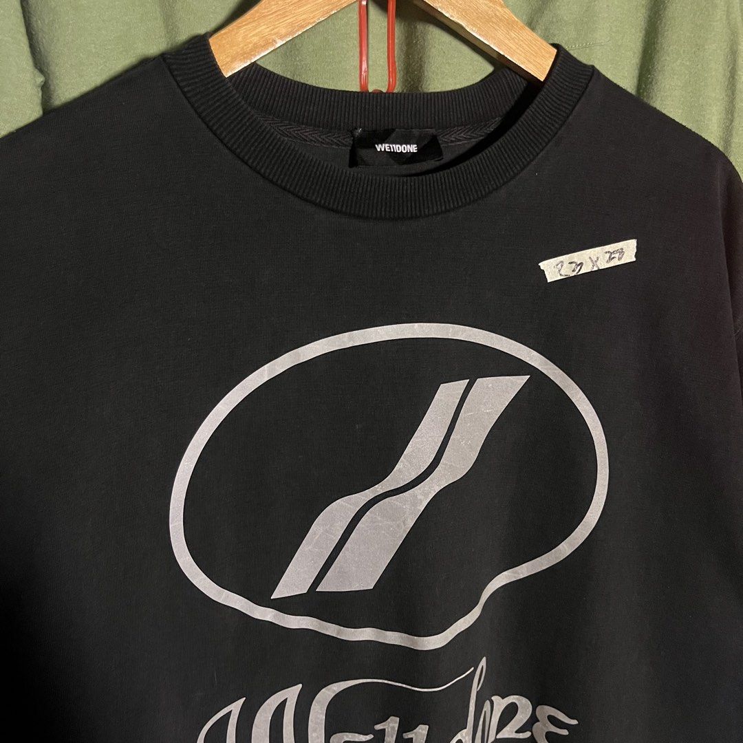 Well Done Black Graphic T-Shirt (Category: Tshirts & Polo Shirts ) located in Caloocan City. Submitted by ayogorenia1002 (Listing ID 1461255791, Image 3). Description: - Black t-shirt with 'Well Done' graphic on front and back. - Features a large oval logo with diagonal lines on the chest. - Tag reads 'Well Done'. - Approximate measurements: 22 inches (width) x 29 inches (length). - Perfect for casual everyday wear..