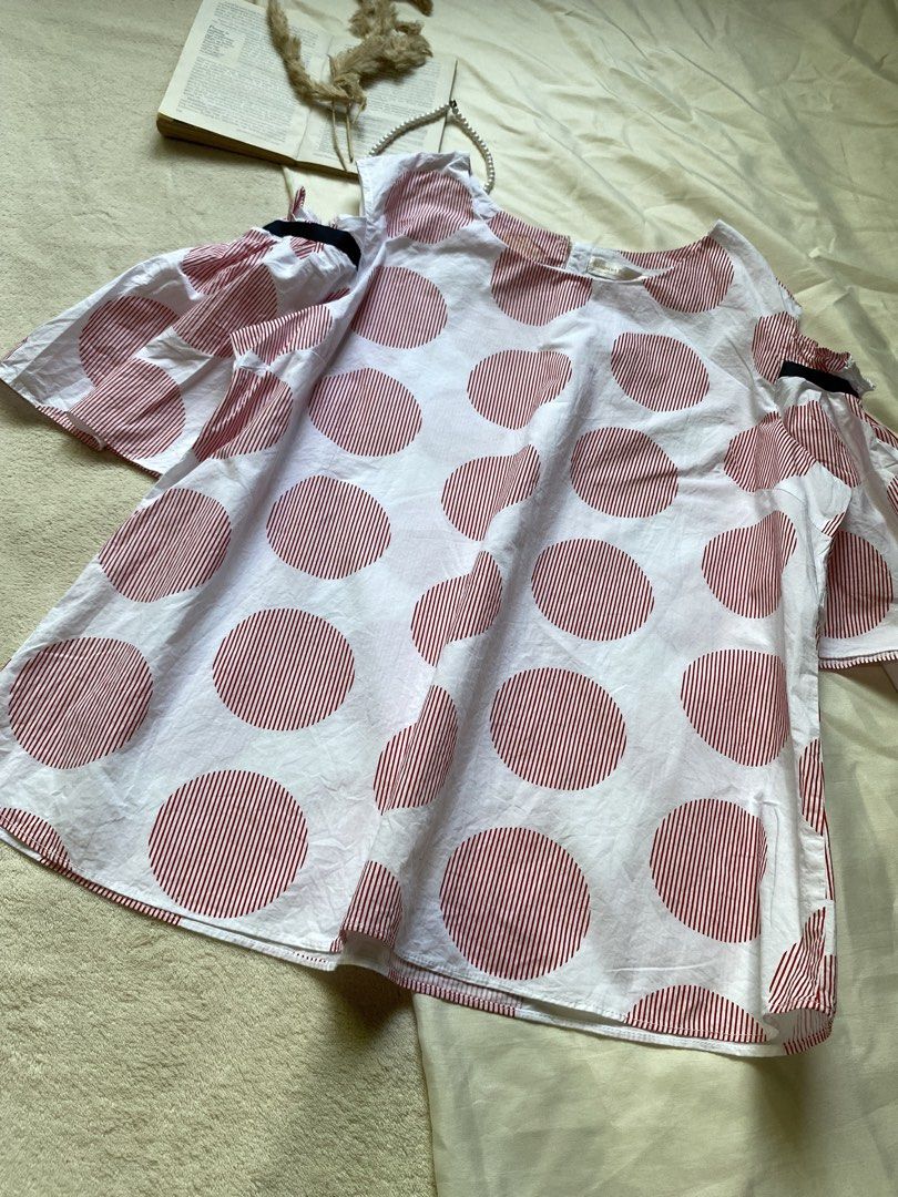 White and Red Polka Dot Cold Shoulder Top Large 40 (Category: Blouses) located in Poro. Submitted by joyceyuu (Listing ID 1461303429, Image 2). Description: - White top with large red polka dots - Cold shoulder sleeves with black ribbon detail - Flared sleeves - Estimated size: Medium - Ideal for casual outings.